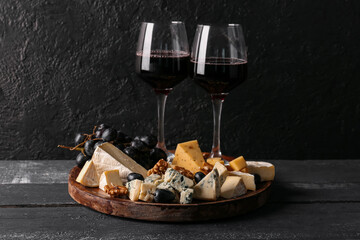 Fototapeta na wymiar Pieces of tasty cheese and glasses with wine on table