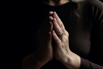 unrecognizable Woman praying with her hands folded