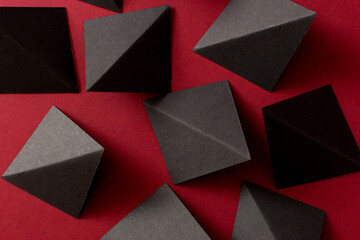 Black triangle shapes on red background, top view