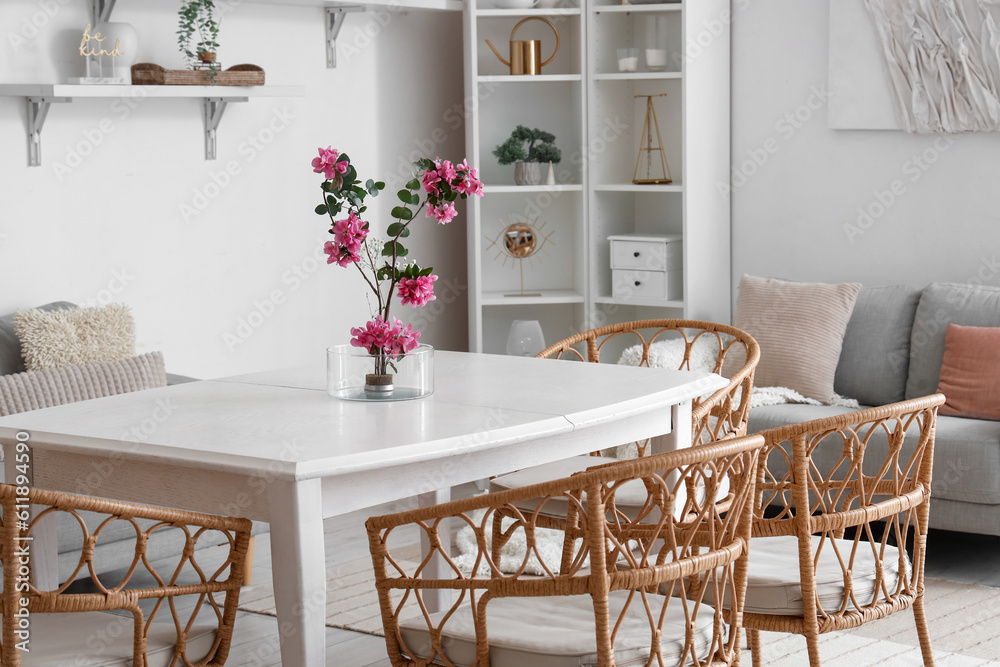 Wall mural Beautiful ikebana on dining table in room