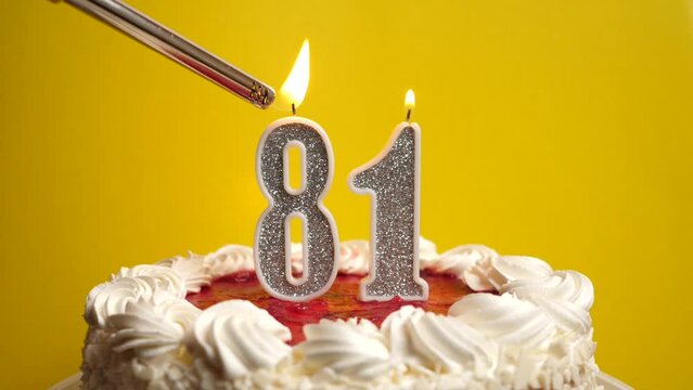 A candle in the form of the number 81, inserted into the holiday cake, is lit. Celebrating a birthday or a landmark event. The climax of the celebration.
