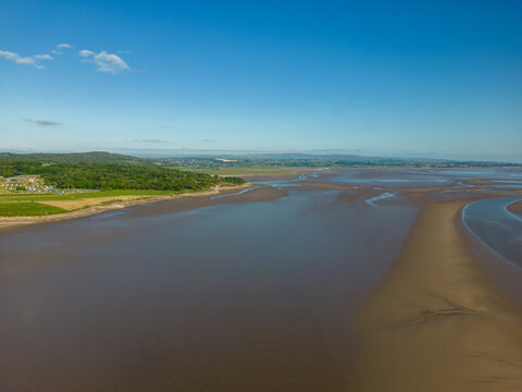 This aerial drone photo shows the large beach at Silverdale. Silverdale is a small village at the Morecambe bay, England. There is a low tide and it's summer. 