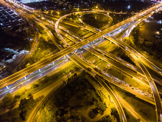 Fototapeta na wymiar Aerial circular intersection transport city road at night with light