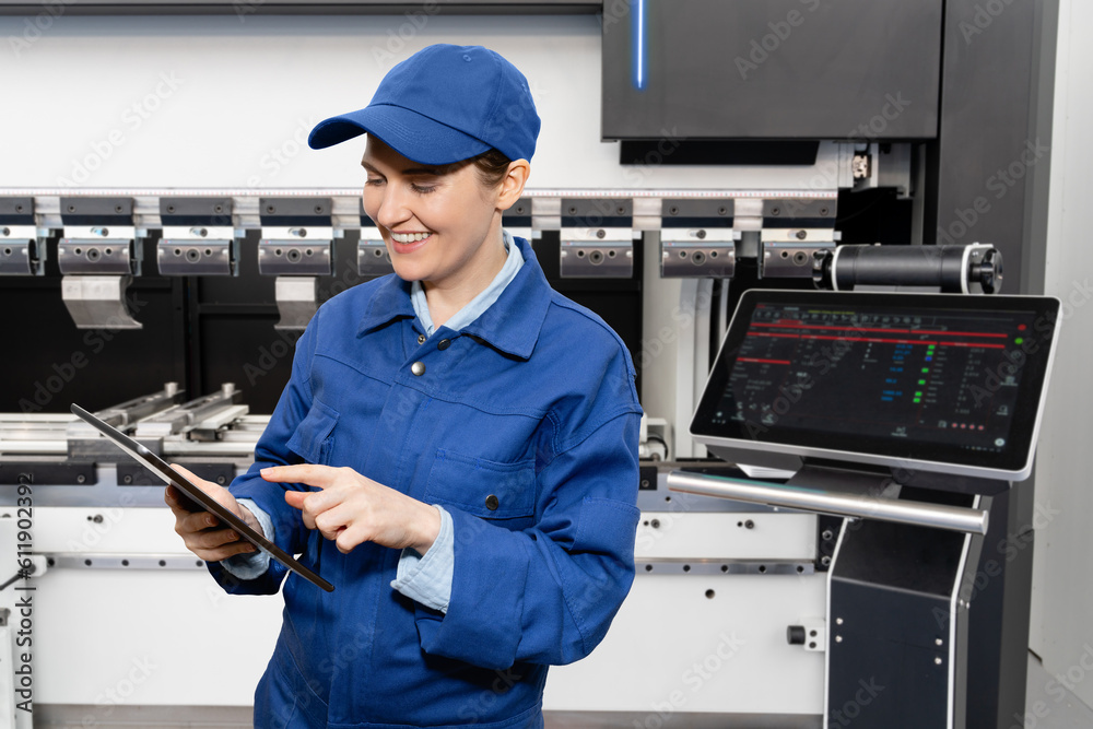 Aufkleber Worker with digital tablet controls automatic machine tool in smart factory