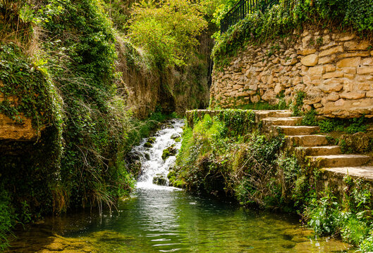 Beautiful waterfall in a middle of a town Tobera. Beautiful green wild nature with a lot of trees.