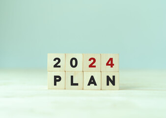2024 business plan and strategies. Goal, plan, action. Annual plan and development for achieving golas. Goal acheiveement and success in 2024. Woden cubes written 2024 and plan on smart background.