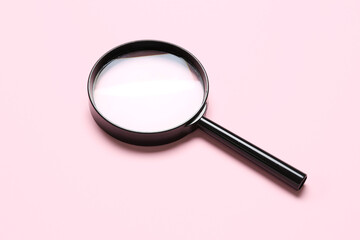 Black magnifier on pink background