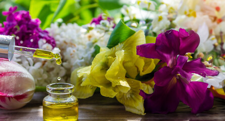 Obraz na płótnie Canvas essential oil of flowers drips into a jar. selective focus.