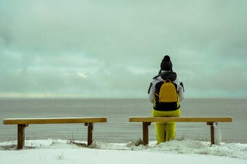 Naklejka na ściany i meble two romantic benches on the shore of the snowy sea and women