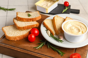Wooden board with boxes of processed cheese, toasts and vegetables on white tile background