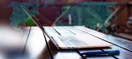 Laptop with digital world map on screen. Global business concept.