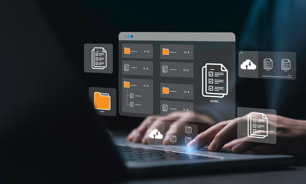 Businessman using a computer to document management concept, online documentation database and digital file storage system or software, records keeping, database technology, file access, doc sharing.