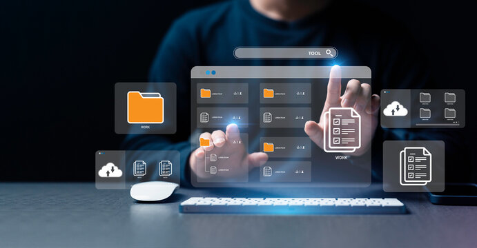 Businessman using a computer to document management concept, online documentation database and digital file storage system or software, records keeping, database technology, file access, doc sharing.