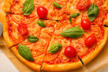 Baking paper with tasty pizza margarita, closeup
