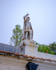Fototapeta premium Porto, Portugal - 2023. Little statue on a roof.