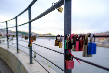 Padlocks locked on a fence in Porto / Vila Nova de Gaia, Portugal - 2023.