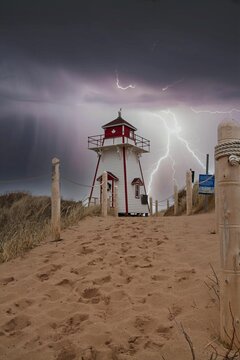 Stormy lighthouse on sand dune in Prince Edward Island