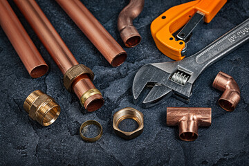 Copper Pipes And Fitting Connectors For Plumbing On Black Background.