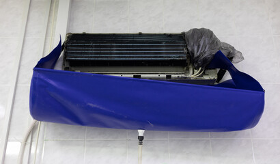 The open ceiling air conditioner is ready to be cleaned from dirt and dust. Under the air...
