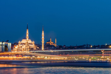 Fototapeta premium Istanbul cityscape - panoramic scenic view of mosque with ferry boat at sunset. Long exposure landscape of Istanbul at night