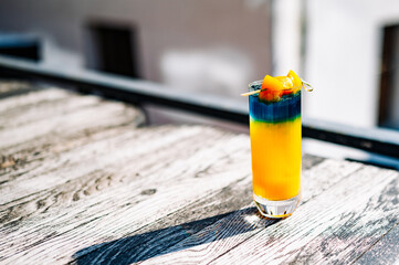 Fresh cold mango cocktail, mango juice smoothie in glass outdoors