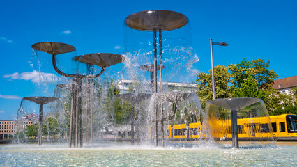 Dresden, Germany - Fountain called Schalenbrunnen in Dresden with famous yellow tram. Cityscape of...