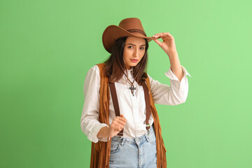 Beautiful cowgirl on green background