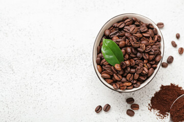 Bowl with coffee beans on light background