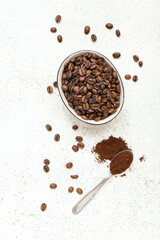 Bowl with coffee beans on light background
