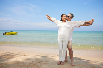 couple hugging and kissing on the beach
