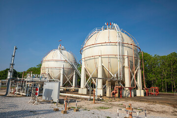 White spherical propane tanks containing fuel gas