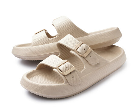 Pair of stylish beige flip-flops on white background