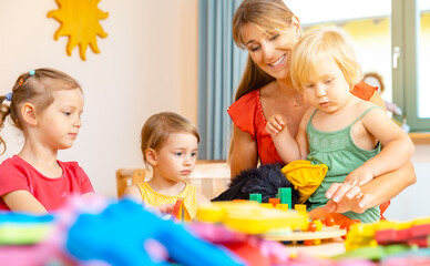 Play school teacher with her students and lots of toys
