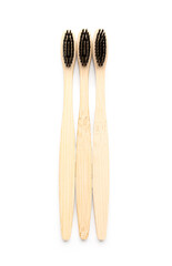 Bamboo toothbrushes on white background