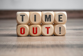 Cubes, dice or blocks with message time out! on wooden background