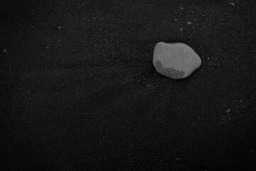wet stone on the black sand beach