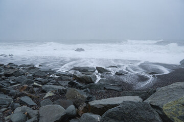 waves and rocks on the black beach