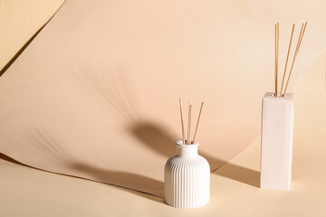 Bottles of reed diffuser on beige background