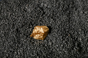Golden nugget on black coal