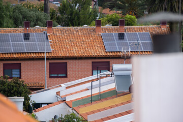 Solar panels on the roof of a single-family house with red bricks and red tiles. Tenerife, Canary...