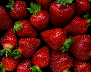 fresh, colorful strawberries isolated on a black background. top view.