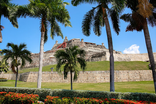 Castle San Felipe de Barajas with palm trees in front on a sunny day, Cartagena, Colombia