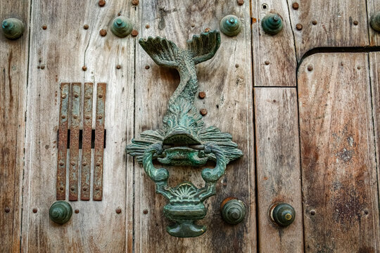 Artful door knocker at an old wooden door, Old Town Cartagena, Colombia