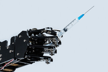 Real robotic hand with syringe. Concept of Artificial intelligence and robots in medicine