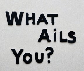 Text "What ails you?" isolated on a grey background. Lettering illustration 