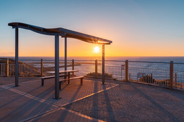 Fototapeta na wymiar Outdoor picnic table on the beach at sunset, O'Sullivan Beach, South Australia