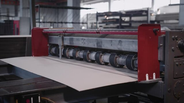 Industrial machine for cutting sheets of cardboard. Production of cardboard boxes for packaging