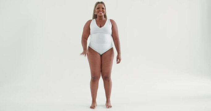 smiling happy plus size beautiful African woman waving hand saying hello hi posing in white sexy bodysuit lingerie, gesture body language Slow motion, sexy hot fat model dancer greeting