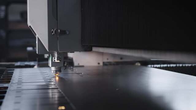 The process of cutting parts from a sheet of metal using a CNC machine. Metal laser cutting technology.