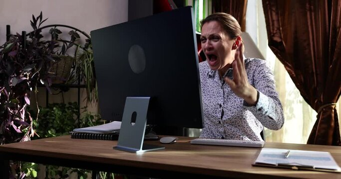 Angry business woman looks at negative business statistics. Financial crisis problem or computer hacking by hackers